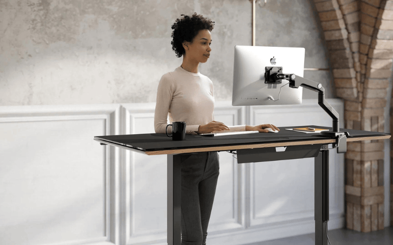 Standing at a standing desk.